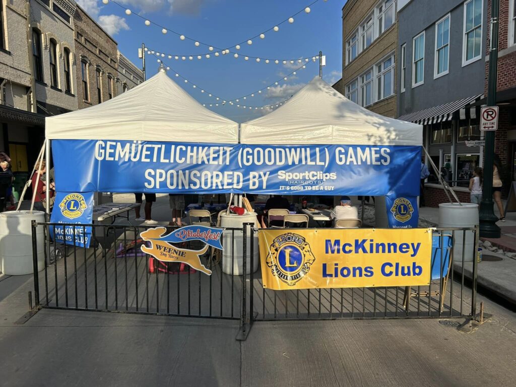 Tents for the McKinney Oktoberfest with the McKinney Lions Club banner